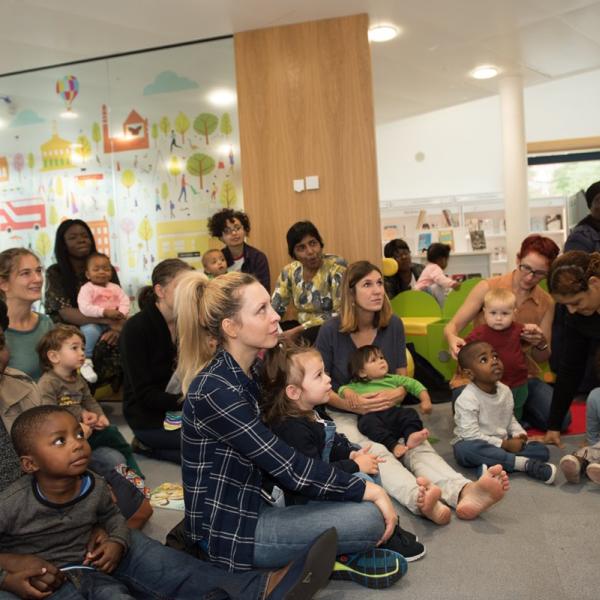 Parents and children sat on library floor